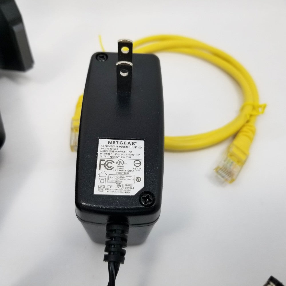 Black power adapter with yellow ethernet cable on a white background