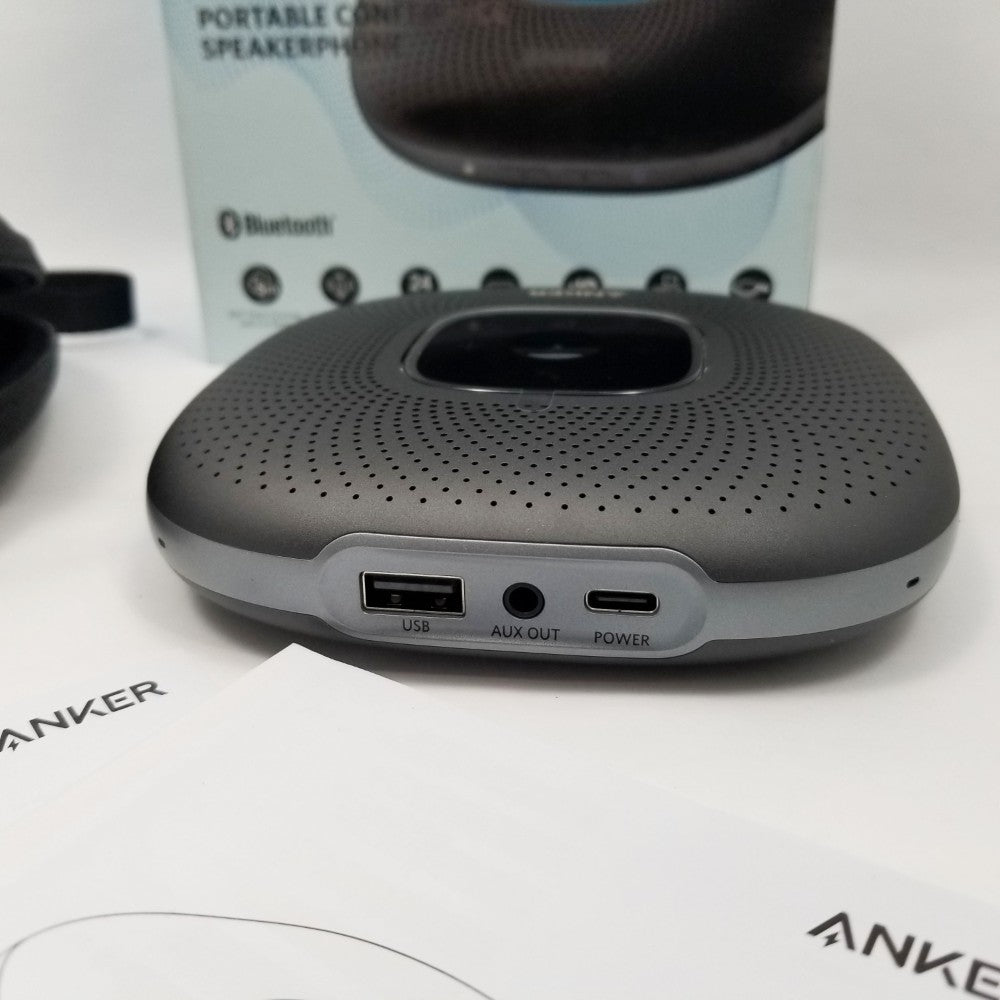 Portable speaker with USB and AUX ports on a white surface, with Anker branding visible.