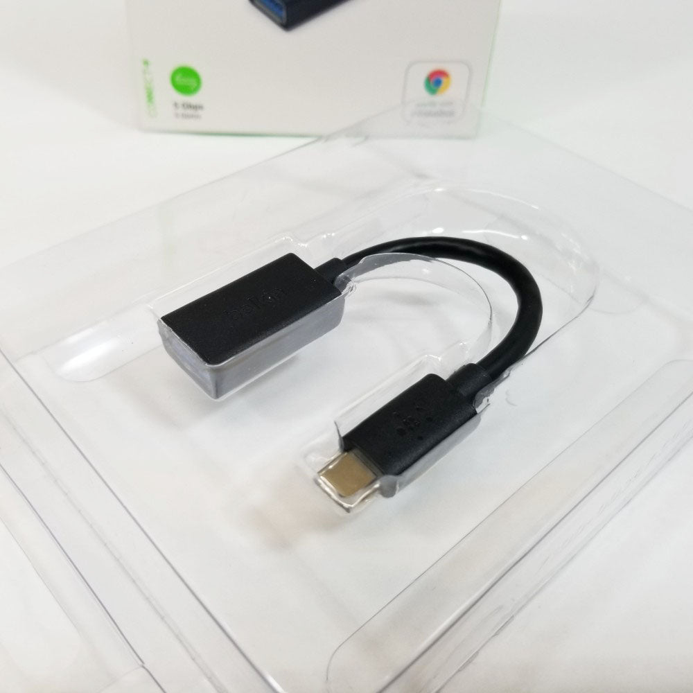 USB adapter in clear blister packaging on a white surface
