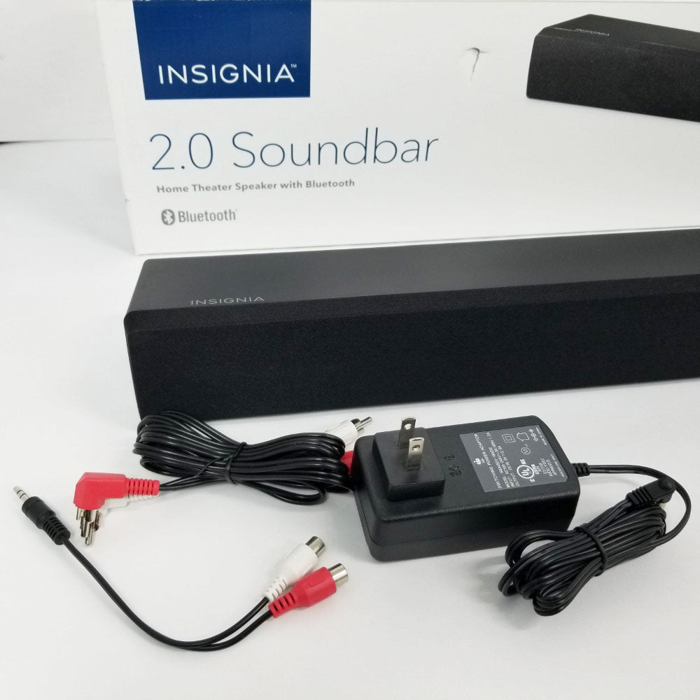 Insignia 2.0 soundbar with power adapter and cables on a white background