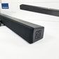 Insignia 2.0 soundbar showing control buttons on the side on a white surface with packaging in the background