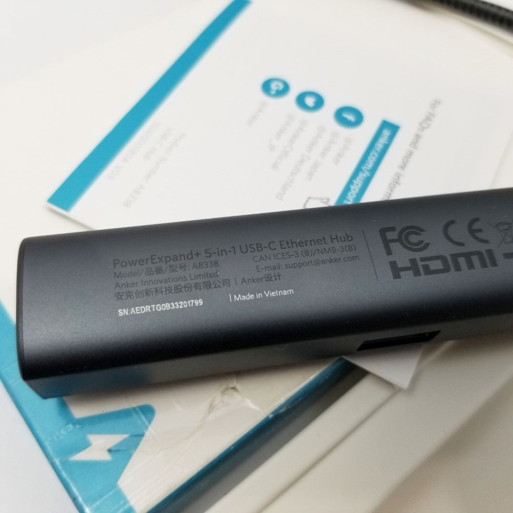 Inscriptions on the back end of the Anker 5-in-1 USB-C adapter all resting on top of packaging material.