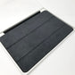 Showing inner fabric surface of Black Apple Smart Cover for iPad mini 4th & 5th Gen lying flat on white surface.