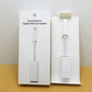 Apple thunderbolt to gigabit ethernet adapter cable propped side by side with it's retail packaging.