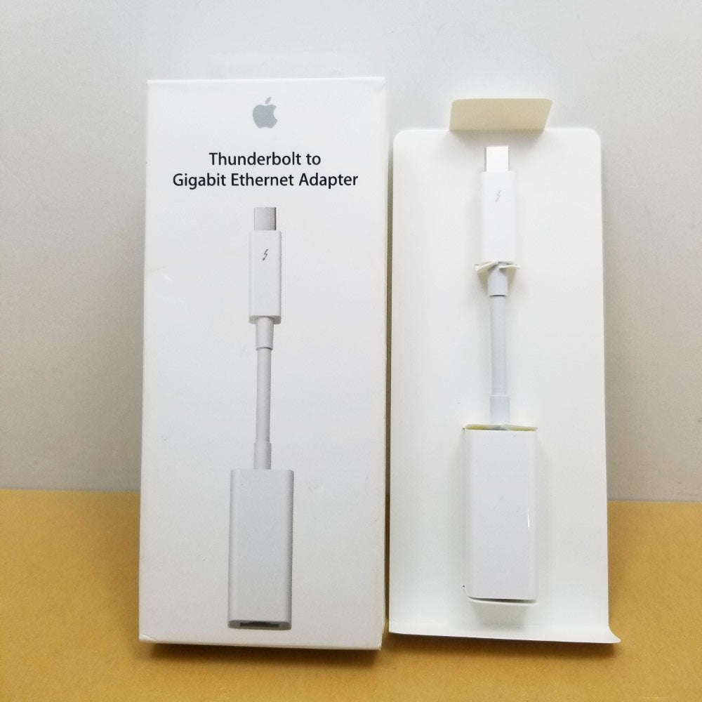 Apple thunderbolt to gigabit ethernet adapter cable propped side by side with it's retail packaging.