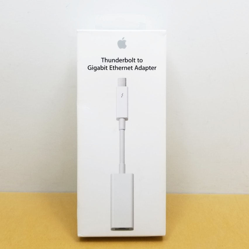 An Apple Thunderbolt to Gigabit Ethernet Adapter in white color, displayed in its packaging.