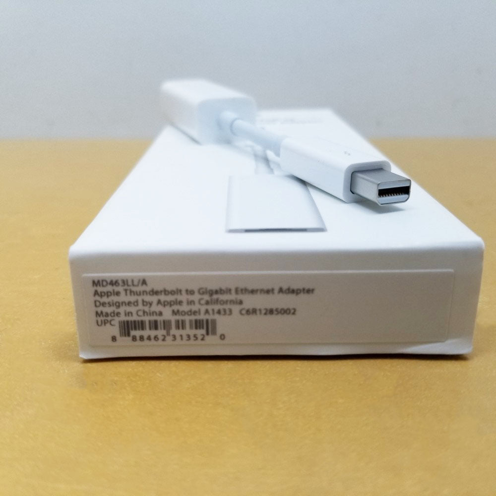 Close up of male thunderbolt plug on adapter and retail packaging showing part number and manufacturer inscriptions.