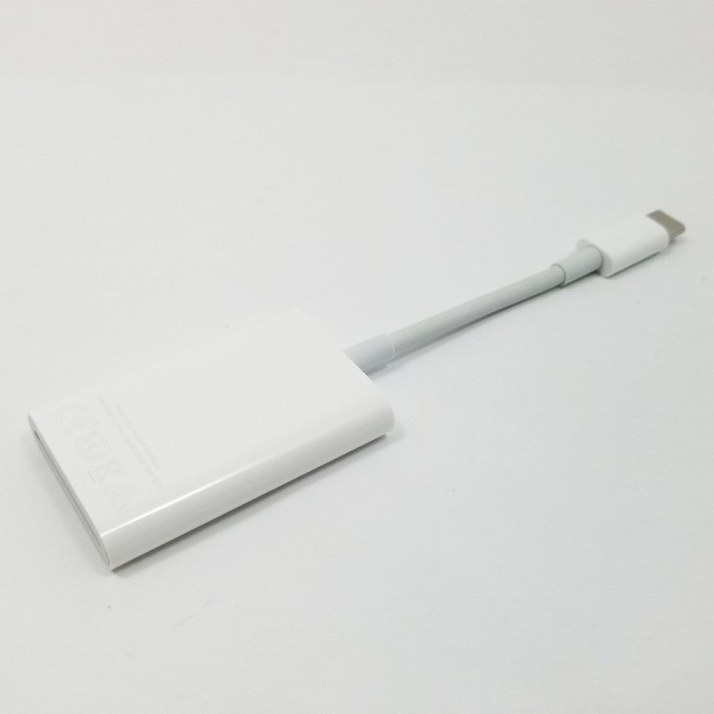 USB-C to SD card adapter resting diagonally on a light gray surface