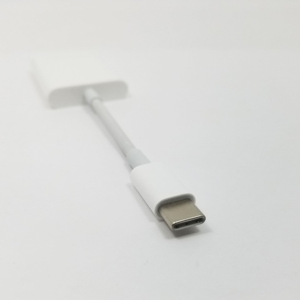 Male USB-C tip of adapter in foreground against a white background