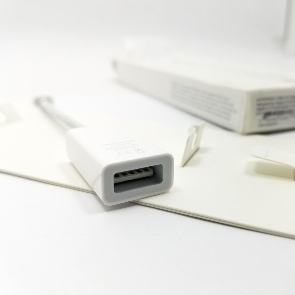 Close up of female port on Apple USB-C to USB-A adapter cable on a white background.