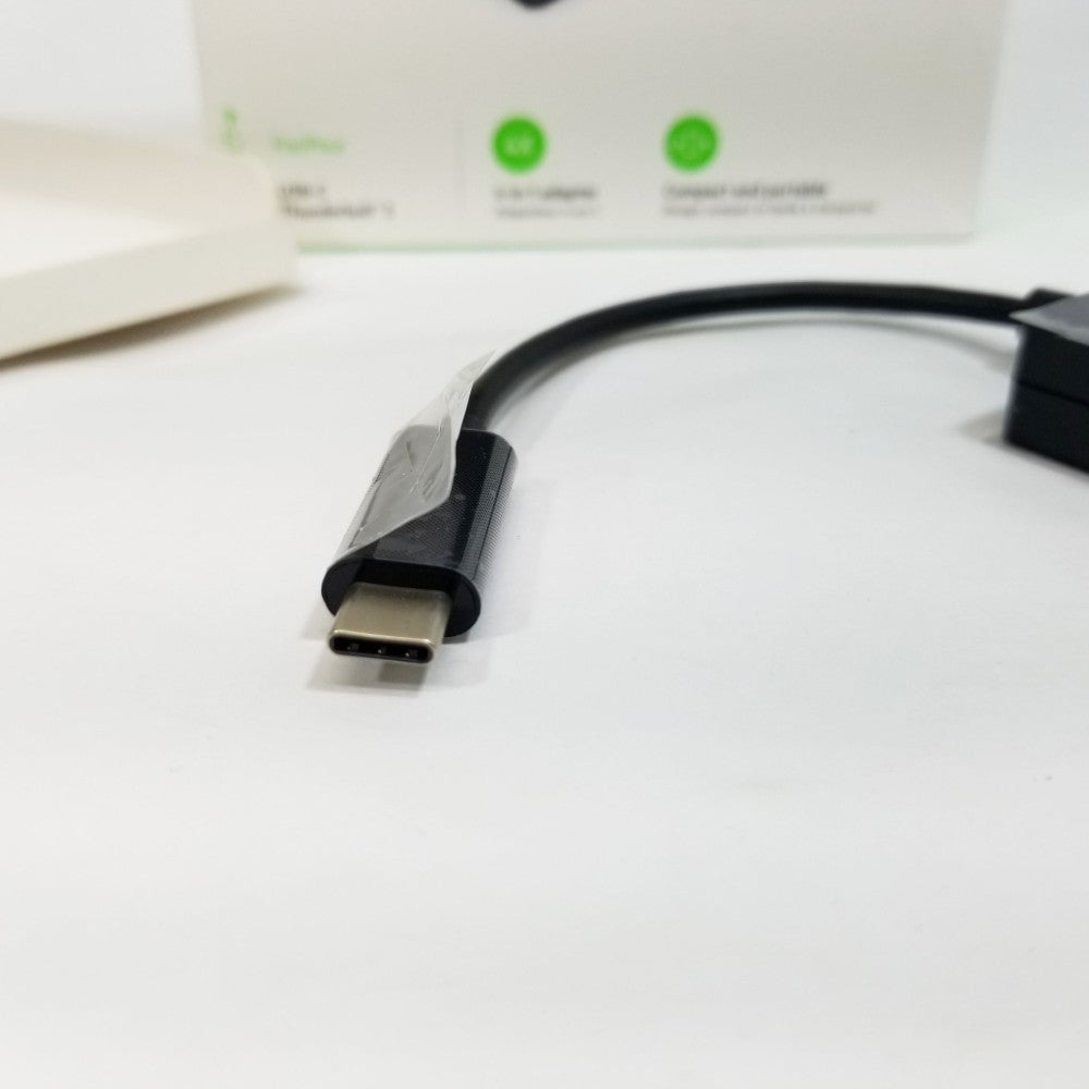 USB-C male plug on a white surface with a blurred background