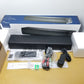 Insignia 2.0 channel mini soundbar with packaging and accessories on a table.
