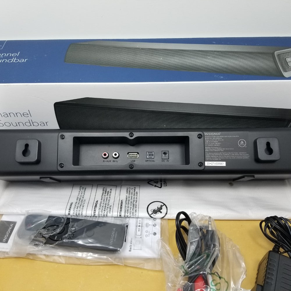 Back end view of soundbar showing ports and number tag. Also shows accessories on a white background