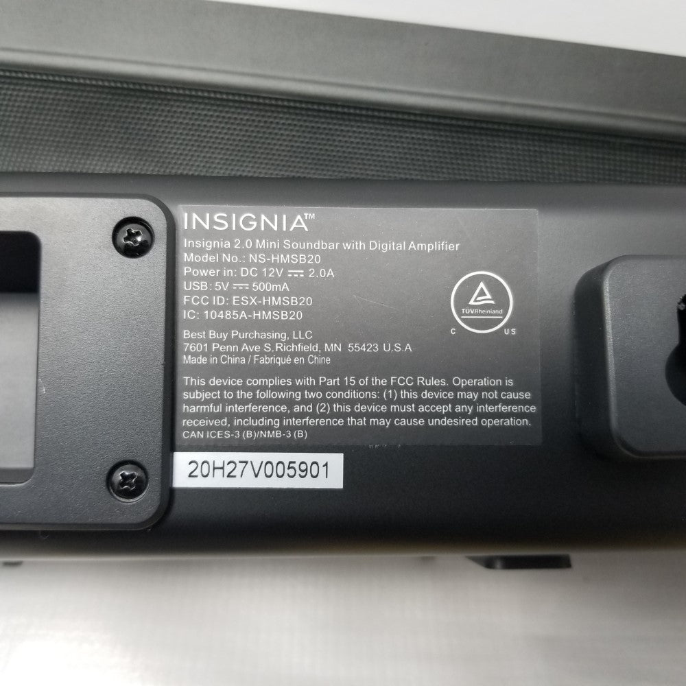 Back panel of an Insignia mini soundbar showing label with part number on a light gray background