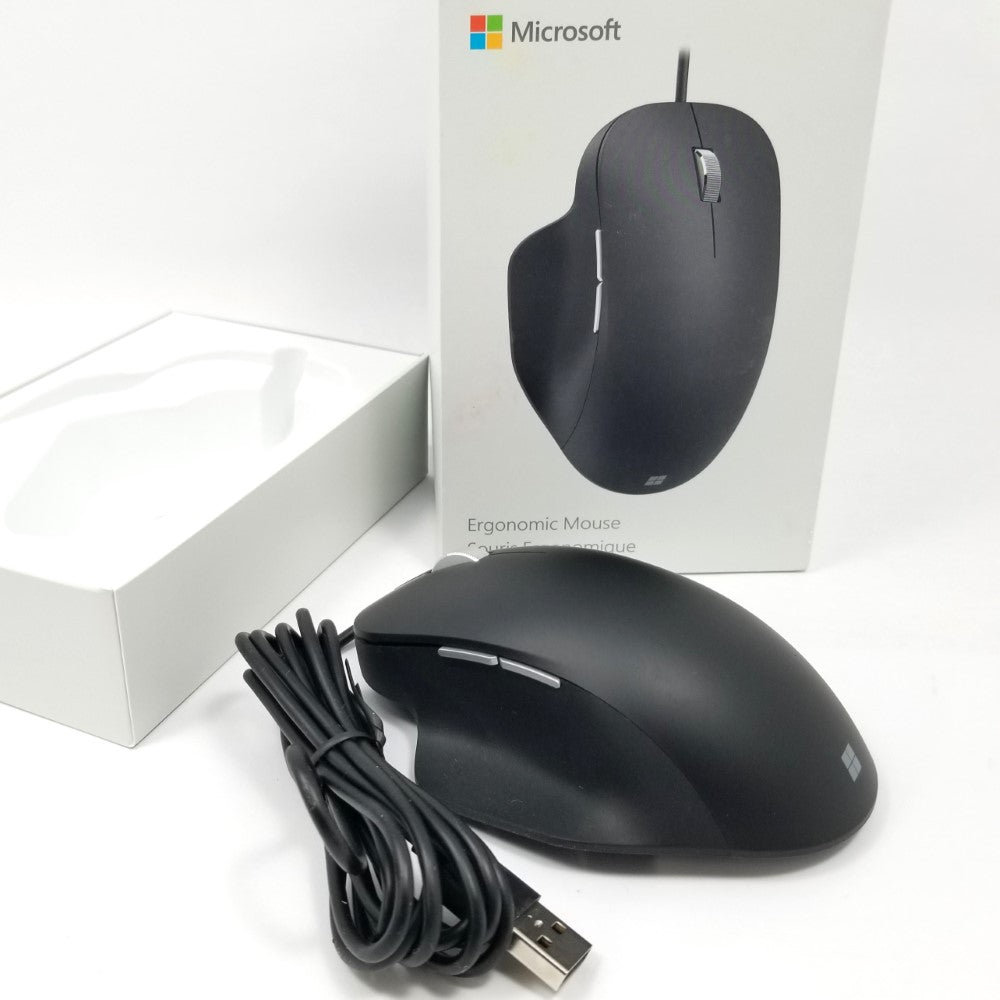 Microsoft wired ergonomic mouse sitting on white surface with packaging in the background