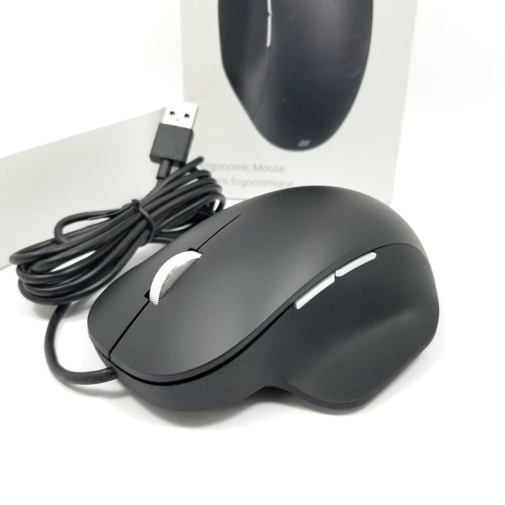 closeup of Microsoft wired ergonomic mouse sitting on white surface showing scroll wheel and buttons  with packaging in the background.