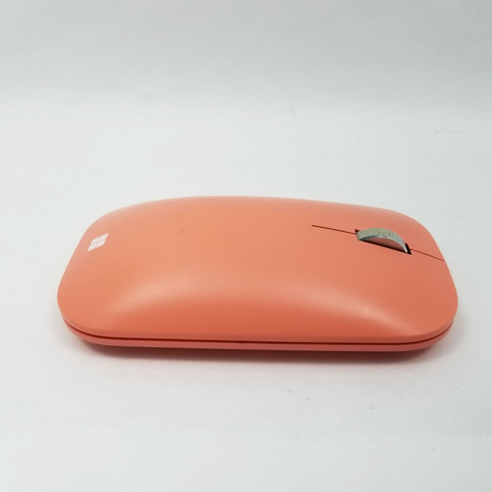 Side profile of peach Microsoft Mobile mouse showing it's curvy design and a scroll wheel.