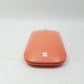 Rear profile of peach Microsoft Mobile mouse showing Microsoft logo.