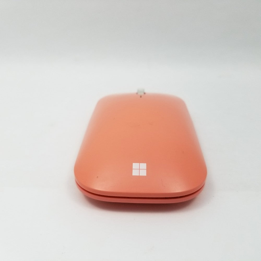 Rear profile of peach Microsoft Mobile mouse showing Microsoft logo.