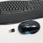 Black keyboard and mouse set with a USB receiver on a white background
