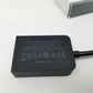 Black power adapter with certification logos on a white background