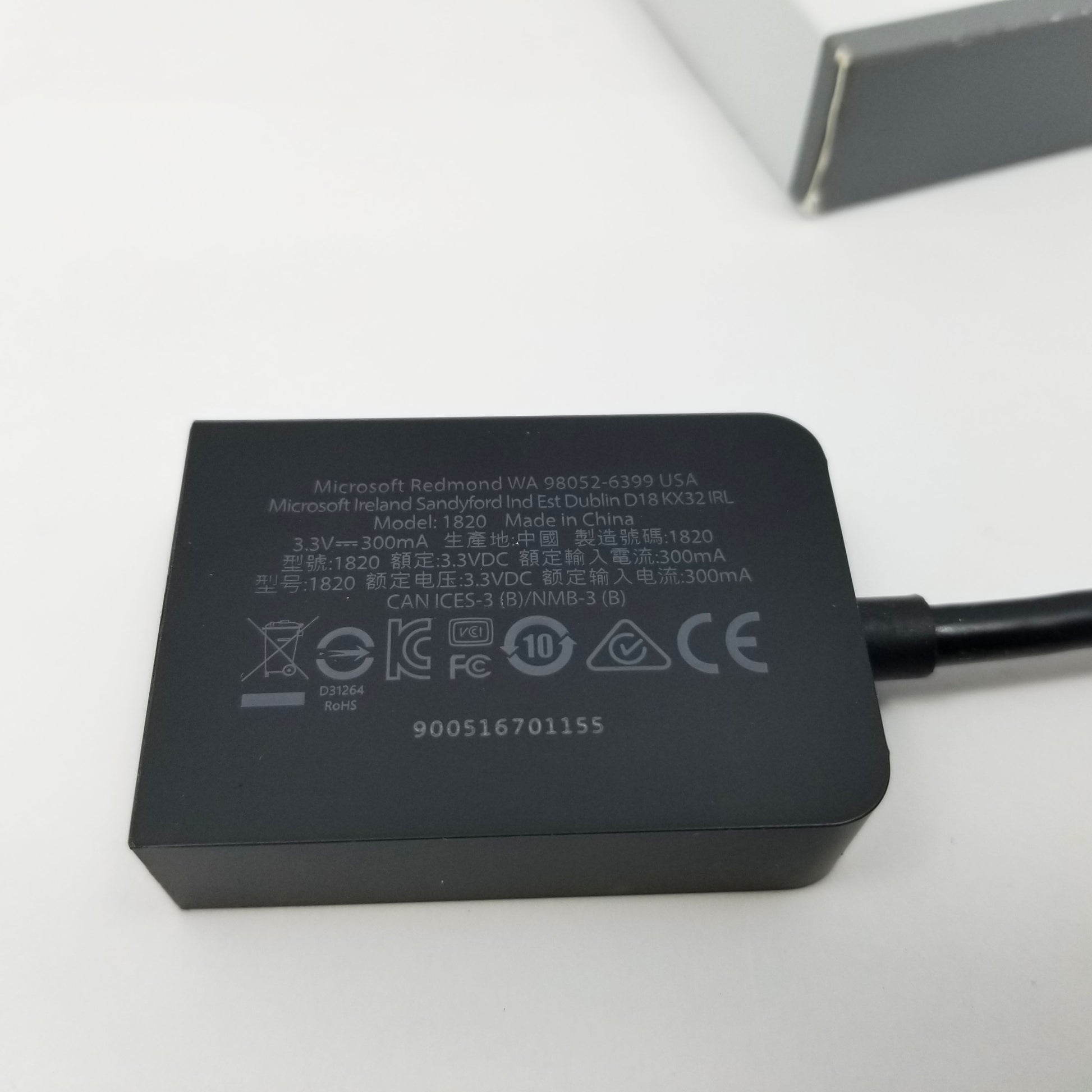Black power adapter with certification logos on a white background