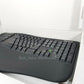 Side profile of Microsoft ergonomic keyboard, showing 10-key pad, sitting inside of open retail packaging.
