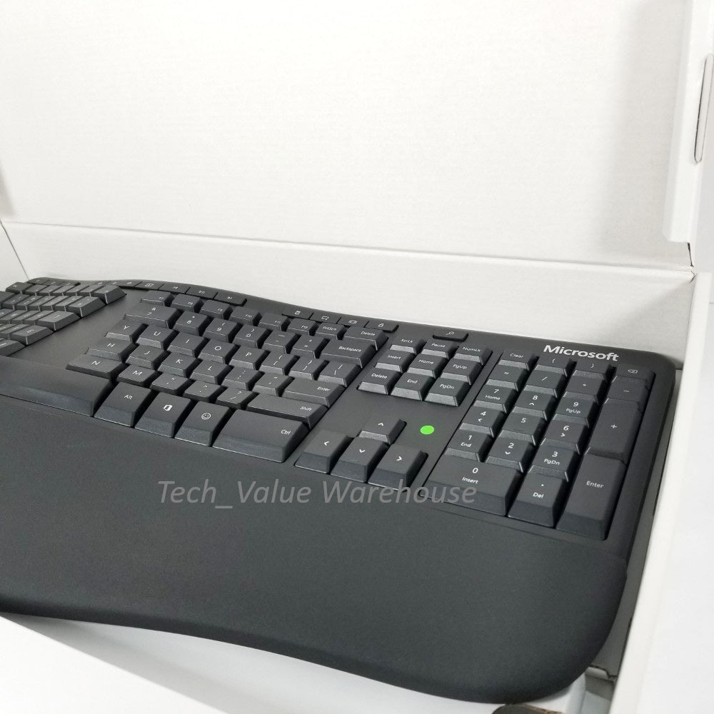 Side profile of Microsoft ergonomic keyboard, showing 10-key pad, sitting inside of open retail packaging.