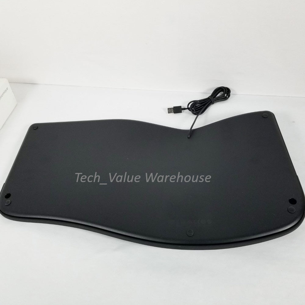 Under side of Microsoft ergonomic keyboard also showing wire and USB plug. against a white background.