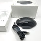 Microsoft wired ergonomic mouse sitting on a white surface with retail packaging sitting in the background,