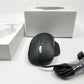 Microsoft wired ergonomic mouse sitting on a white surface with retail packaging sitting in the background,
