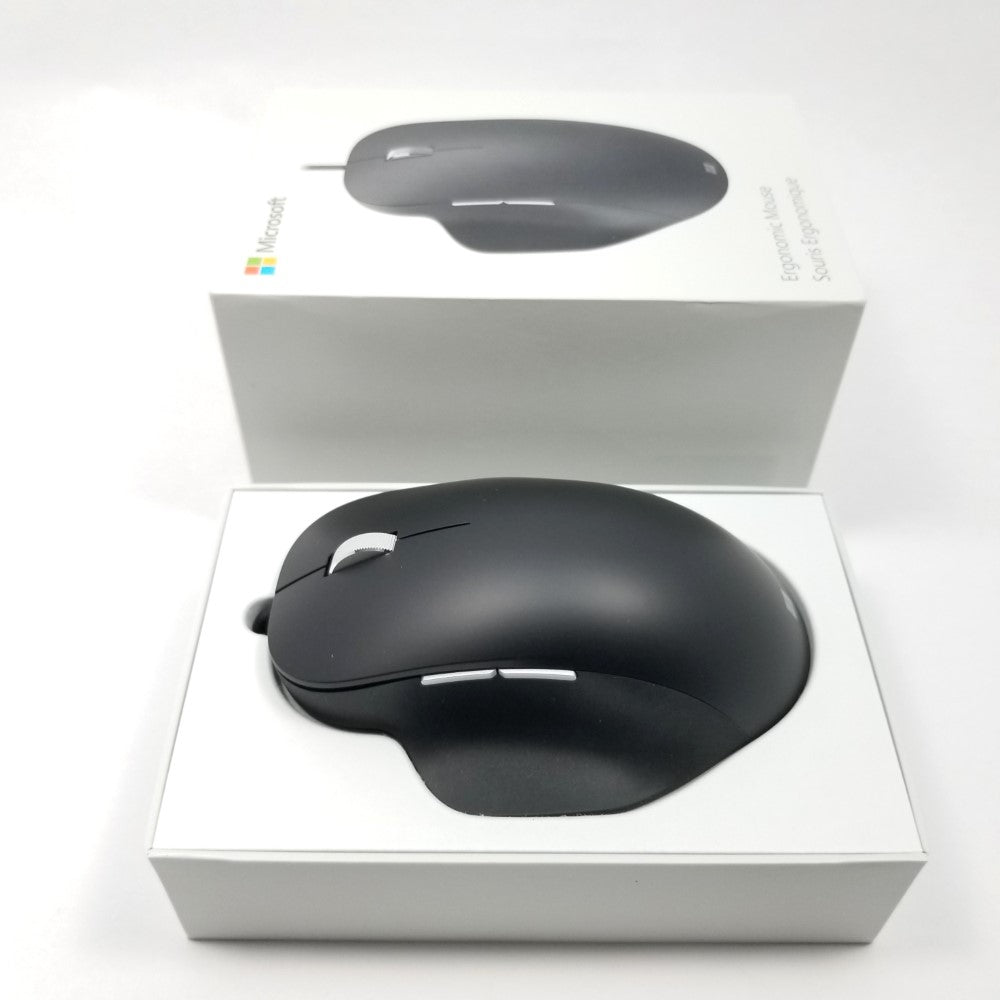 Microsoft wired ergonomic mouse sitting in open retail packaging against a white background,