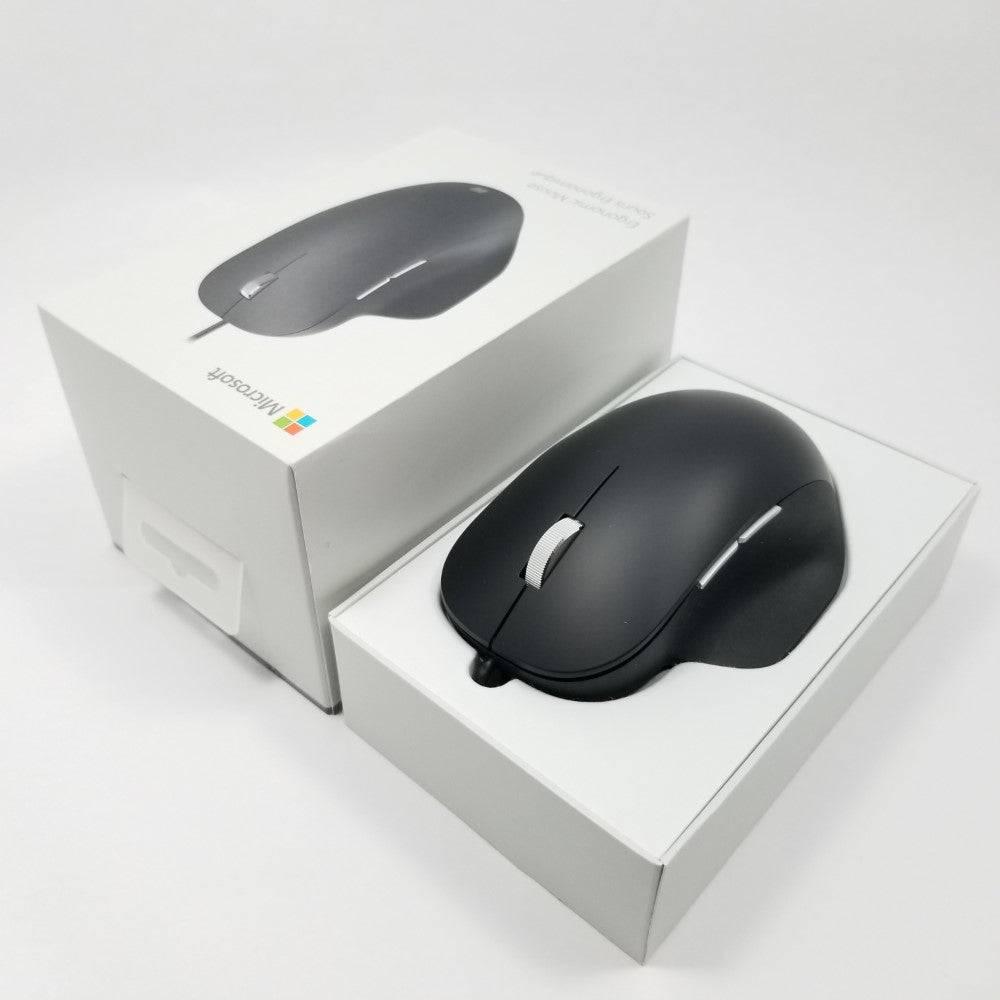 Microsoft wired ergonomic mouse sitting in open retail packaging against a white background,