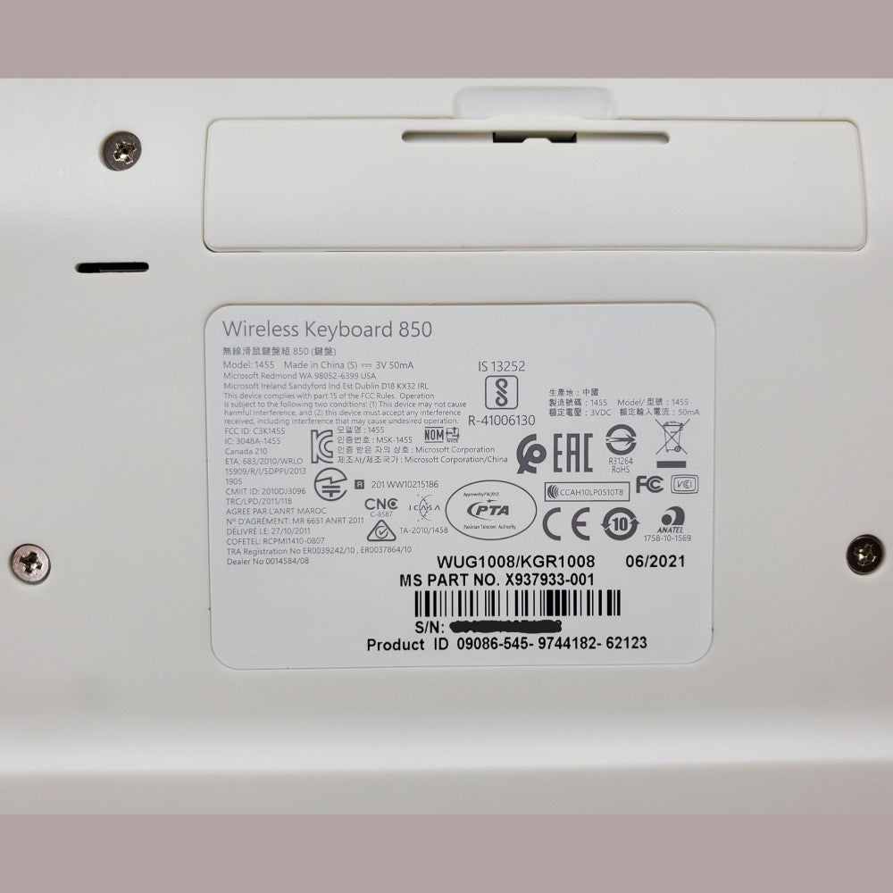 Close up of sticker tag on bottom of keyboard, showing part number and UPC code.