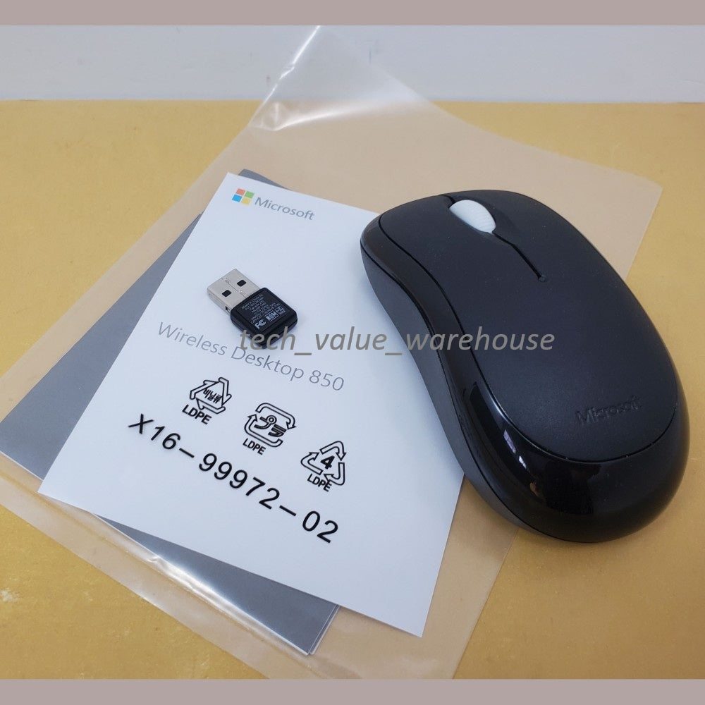 Mouse, receiver and user guide of Microsoft wireless desktop 850 combo sprawled on a beige surface.
