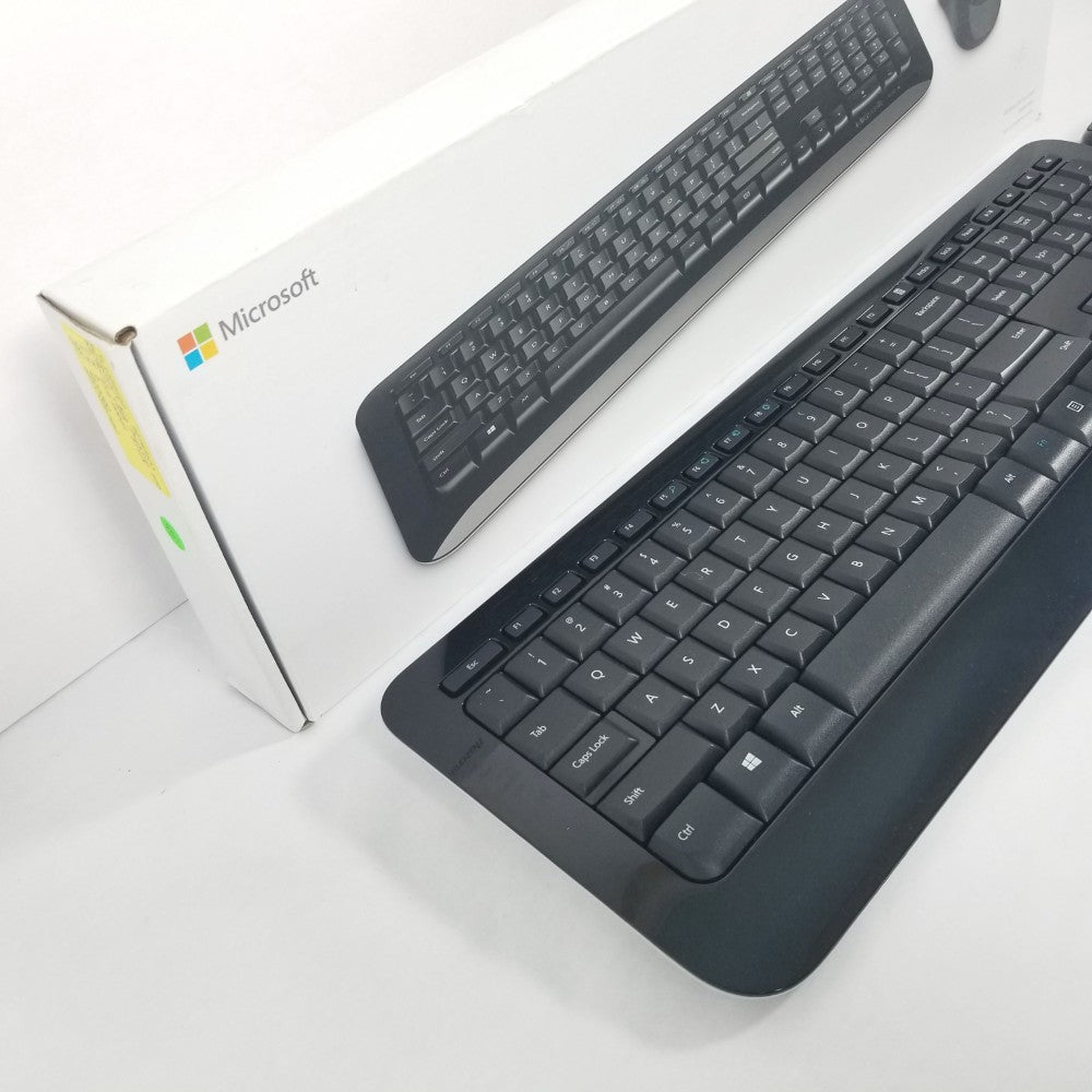 Black Microsoft wireless desktop 850 Keyboard next to retail packaging against a white background.