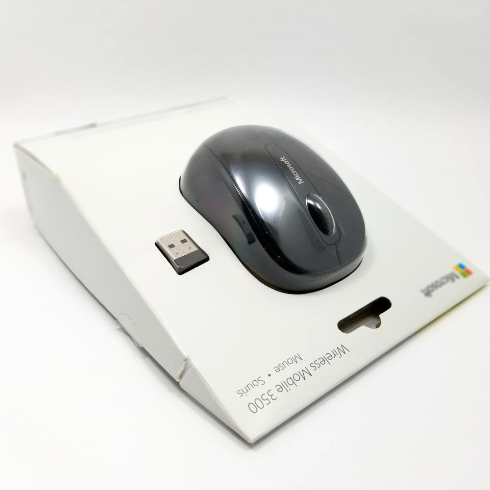 Top side angled view of packaging showing mouse and transmitter on a white background.