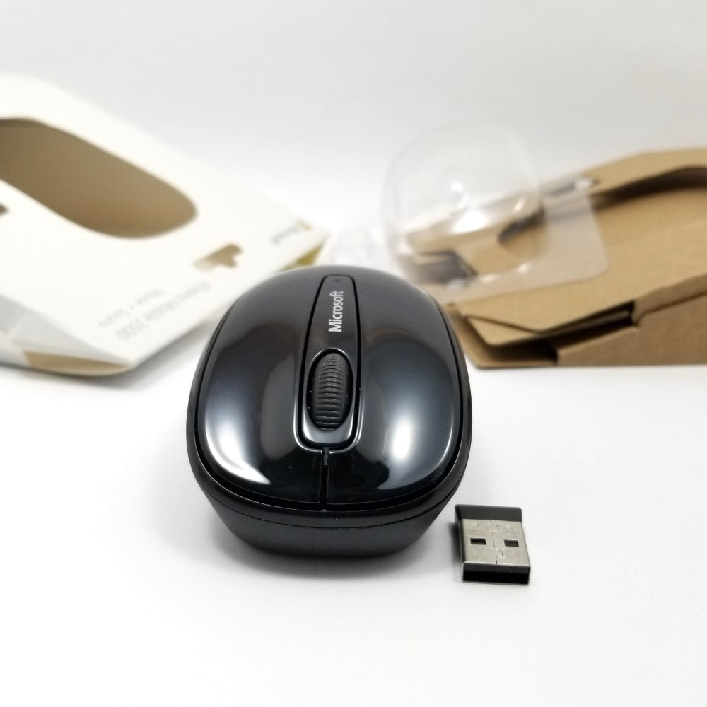 front view of mouse and transmitter on white surface.