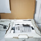 Open box containing electronic equipment with a cardboard cover