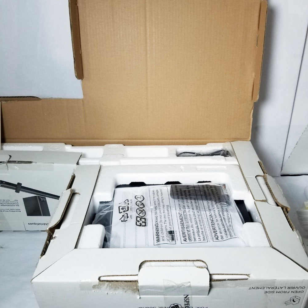 Open box containing electronic equipment with a cardboard cover