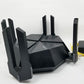 Black router with multiple antennas on a white background