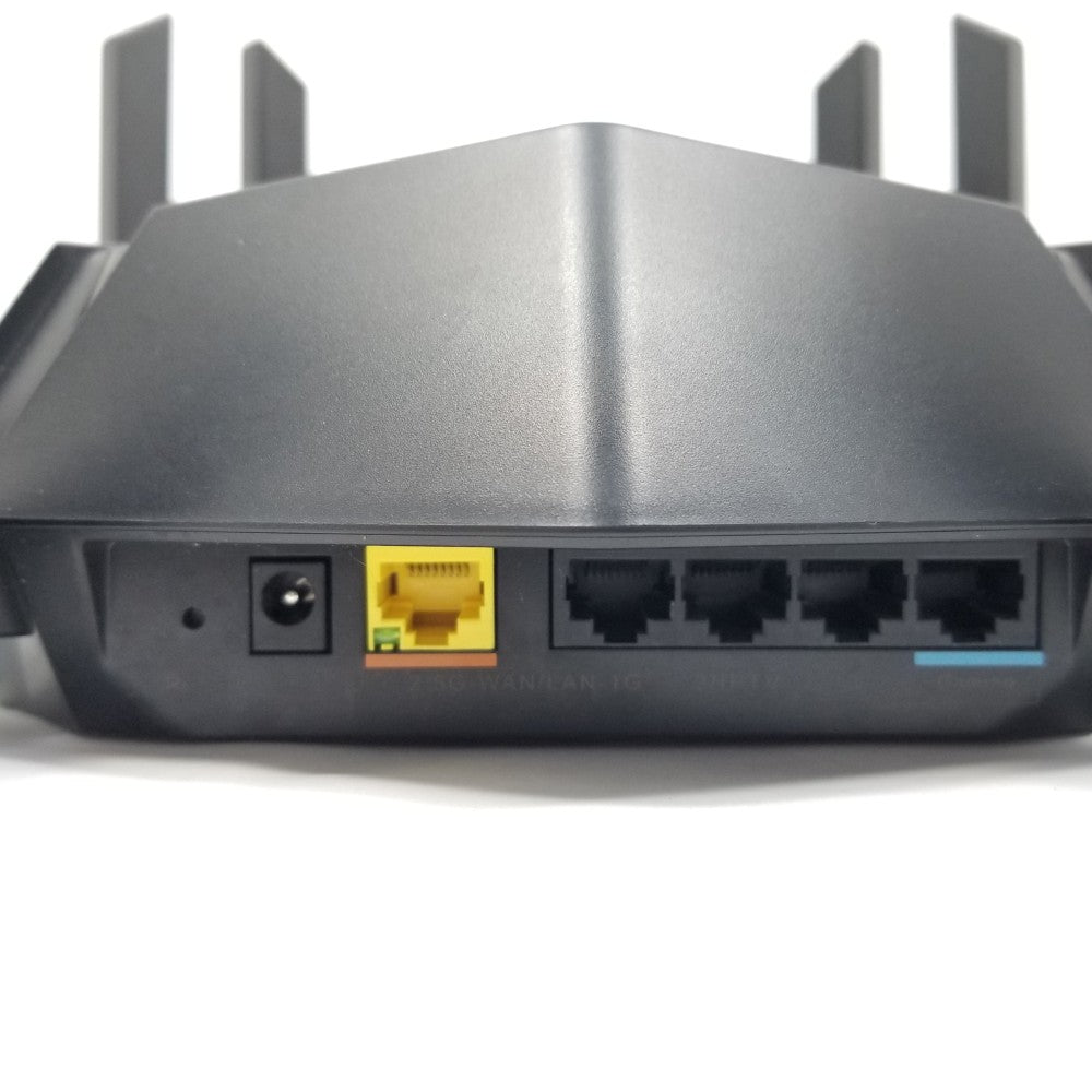 Back view of a router showing power and ethernet ports, all on a white background
