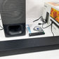 Sony soundbar and subwoofer with remote control, user guides and retail box on a white surface