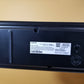 Back view of a Samsung HW-Q60T showing manufacturer labeling on a beige surface