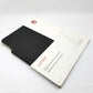UAG Lucent case in retail packaging lying diagonally on a white surface.